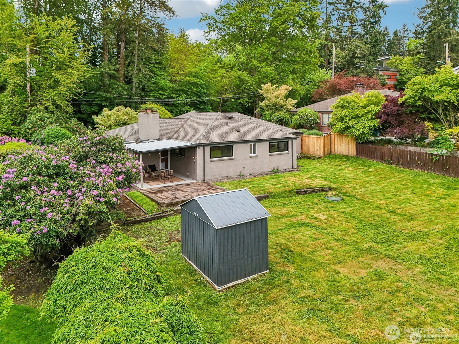 Exterior view highlighting placement of shed to provide additional storage.