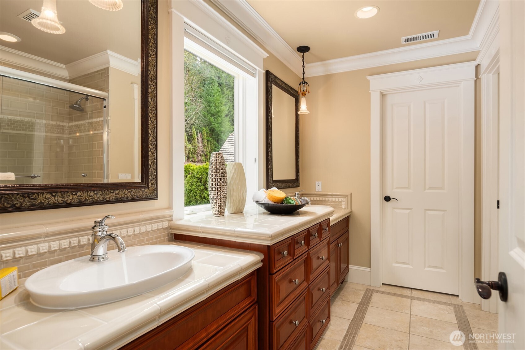 Secondary full bath with dual vanities and designer pendant lighting