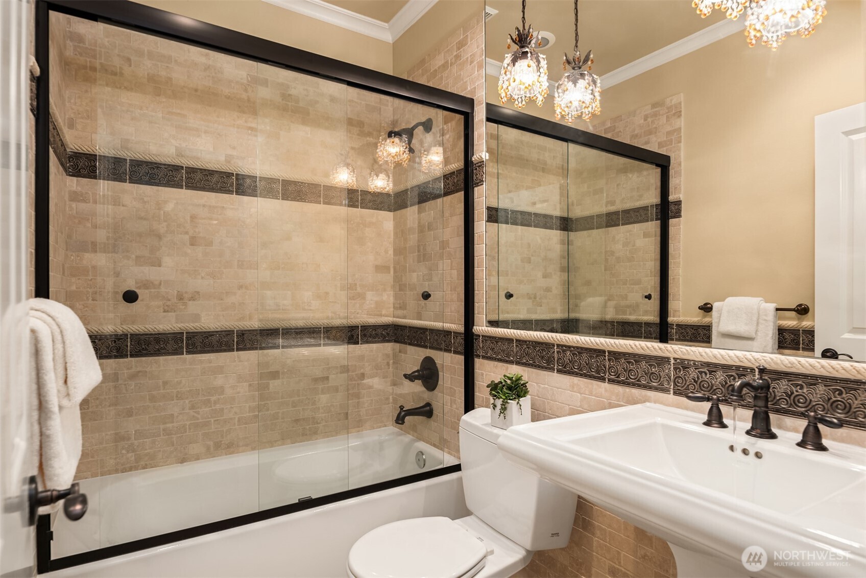 Recreation/Guest Level full bath with stone surround and wainscoting, designer accents