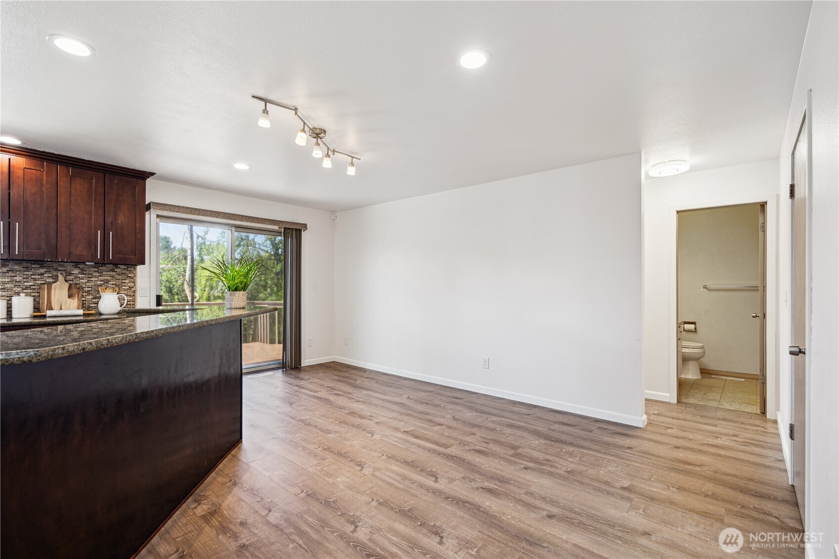 Discreetly tucked around the corner from the kitchen and breakfast nook is the convenient 3/4 bathroom, a rare find in homes.