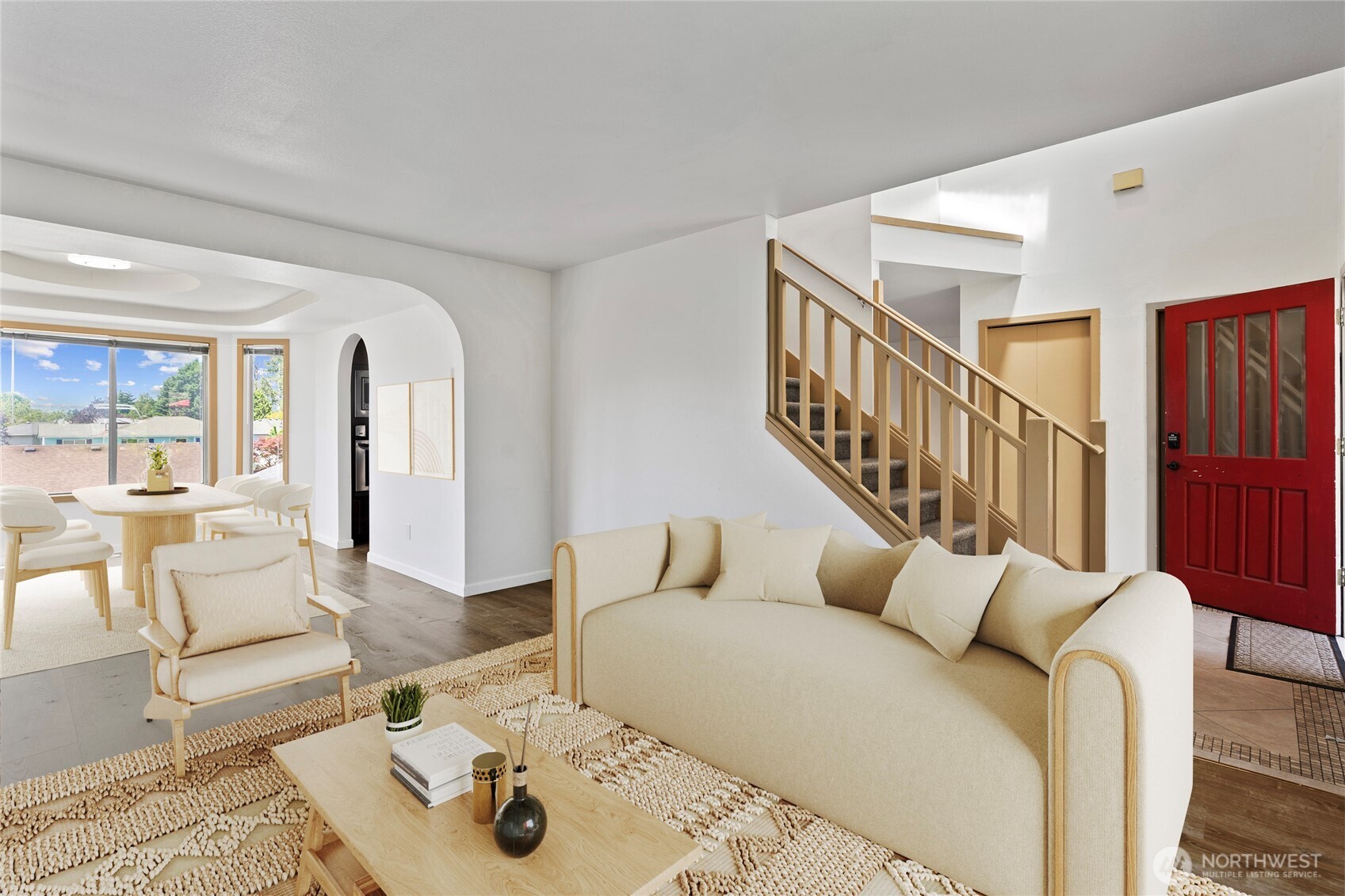 Virtual Staging - Step inside to all new gleaming luxury vinyl plank flooring and new baseboard trims throughout the entire home. Natural light abounds in this open and airy living space, creating a seamless flow and clear sight lines between the formal living and dining rooms. Note the charming arched walls of the formal dining room.