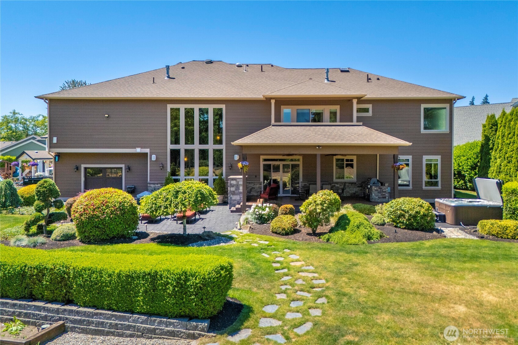 Back of home is great for entertaining. Shop area w/back garage door to the left.