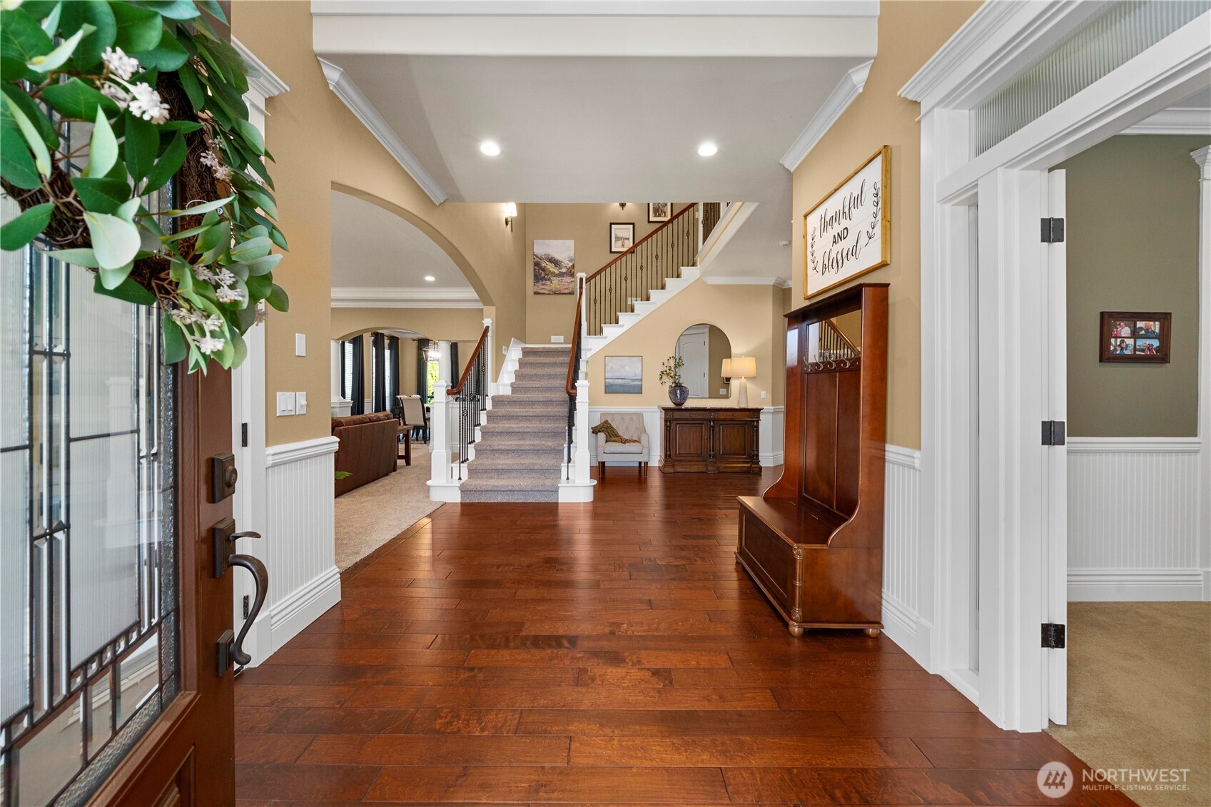 Hardwoods in entry, generous application of millwork throughout. Office to the right, formal areas to the left. 2nd level ahead.