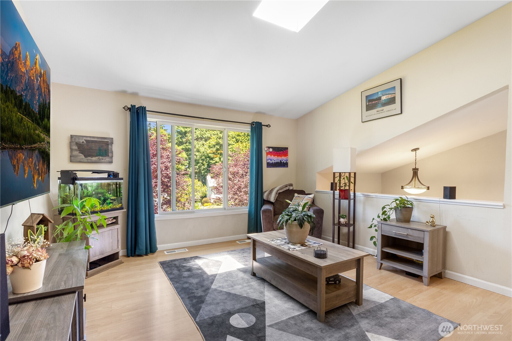 Light, bright, and inviting, this spacious living room offers the perfect blend of comfort and function—ideal for quiet nights in or entertaining a crowd.