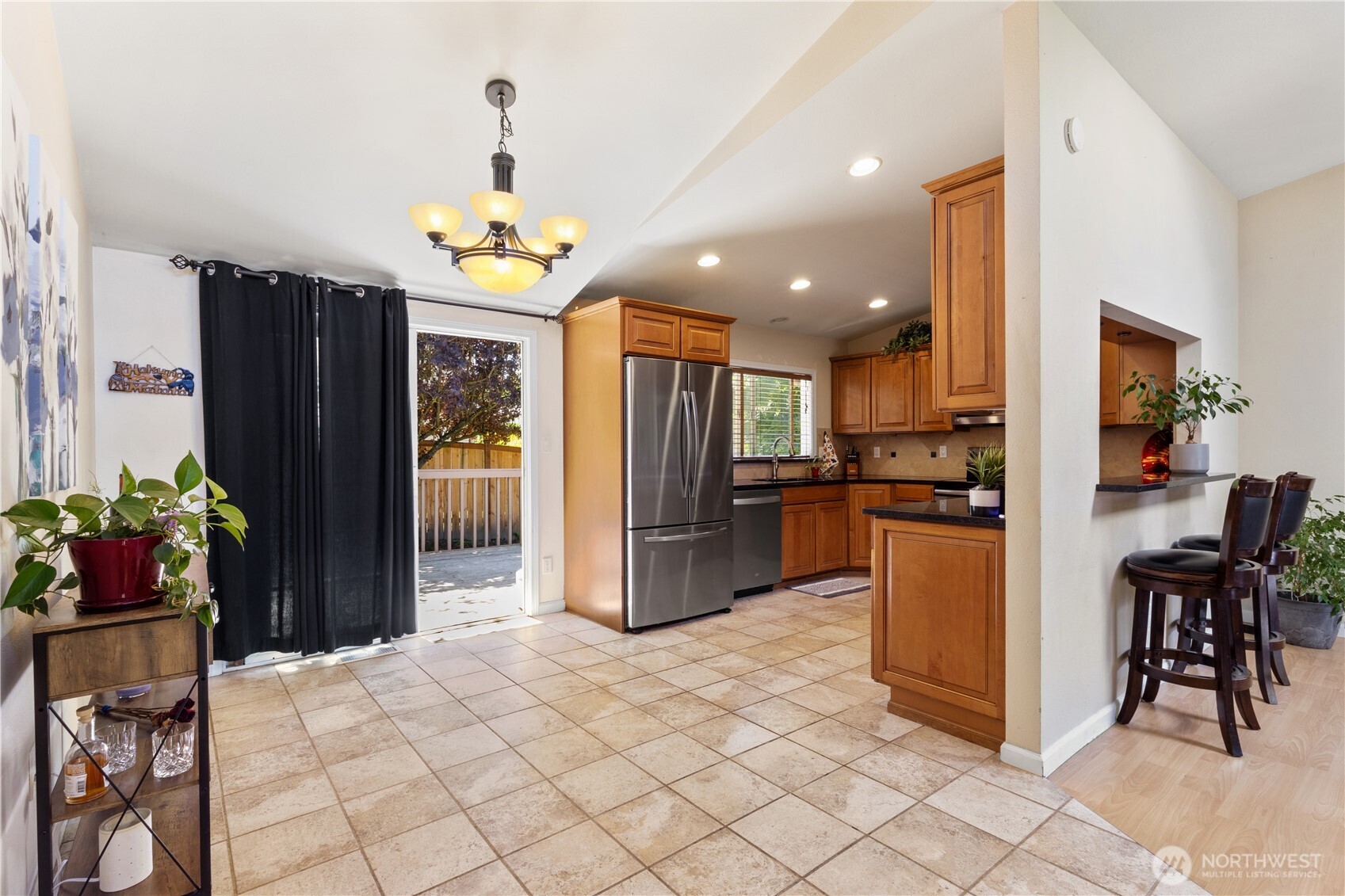 A great view of the dining area, kitchen, and the versatile eat-up bar—ideal for quick bites, homework, or extra seating when guests drop by.