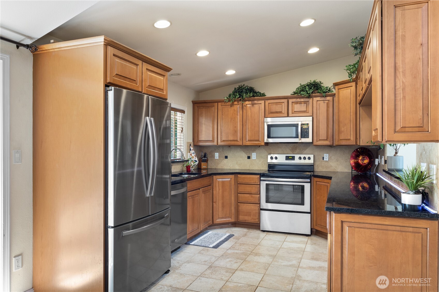 The modern kitchen features generous counters, stainless steel appliances, and room to spread out—perfect for everyday meals or hosting with ease.