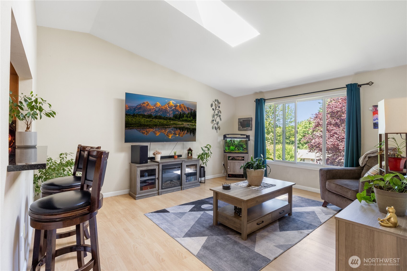 This sun-filled living room feels both cozy and open, with space to unwind for movie night or gather with guests for special occasions.