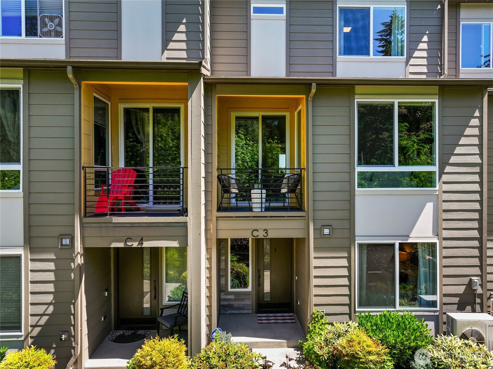 Covered balcony and front entry face the greenbelt.