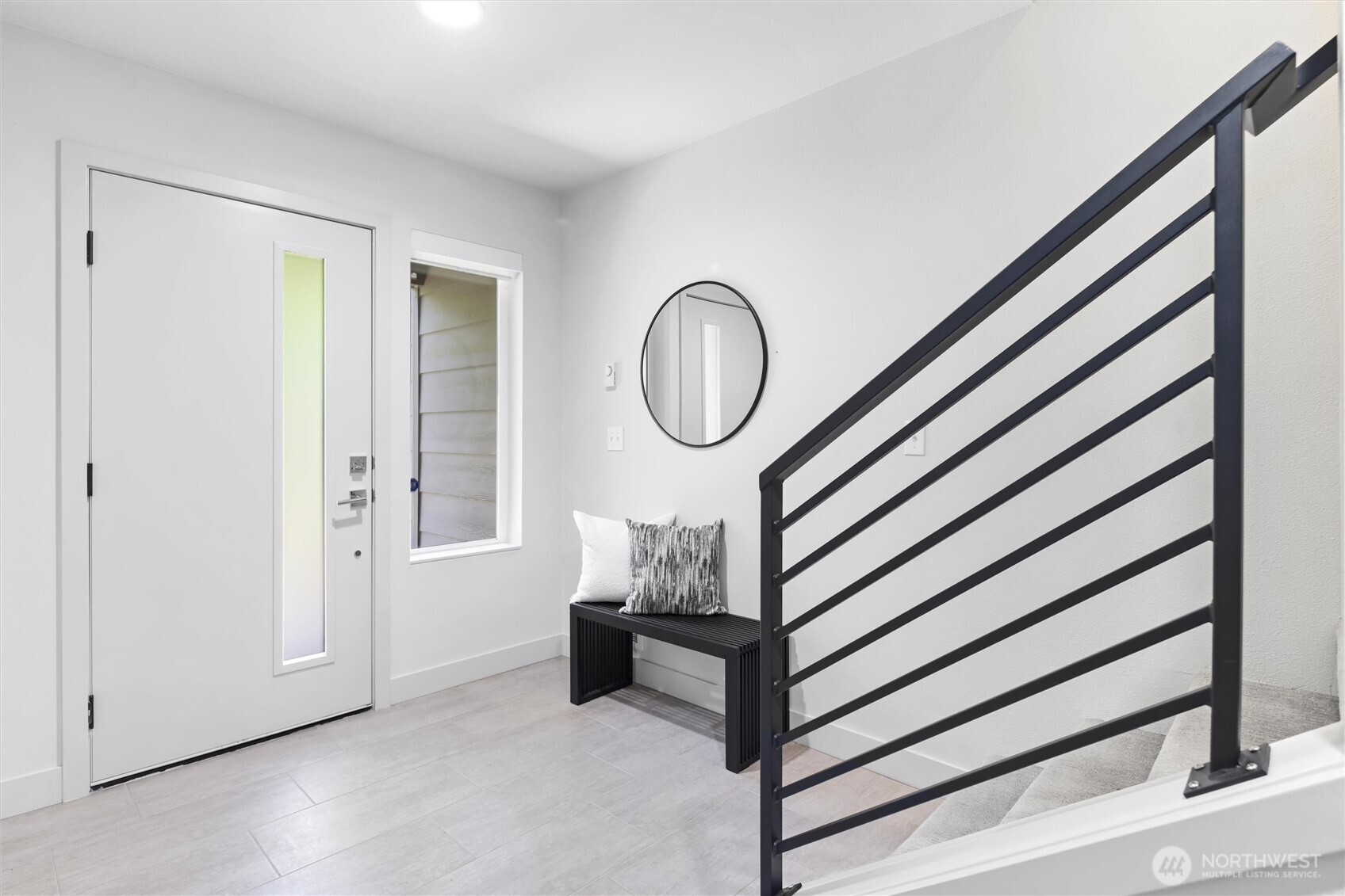 Covered entry on ground level opens to bright foyer with durable tiled floor.