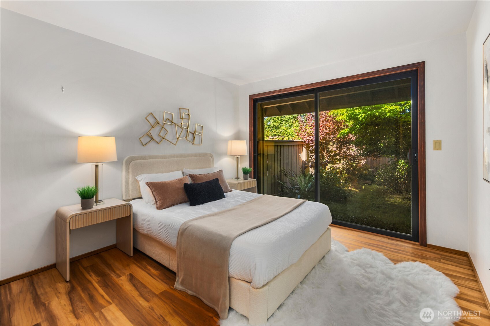 A well sized guest bedroom is situated down the hallway from the front entry, providing main level living, complete with a slider door leading directly to the private yard