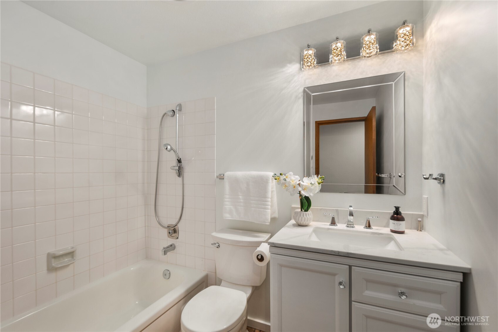 The main floor full bathroom, which has recently been refreshed, is conveniently located directly next to the main floor bedroom, making it perfect for guests