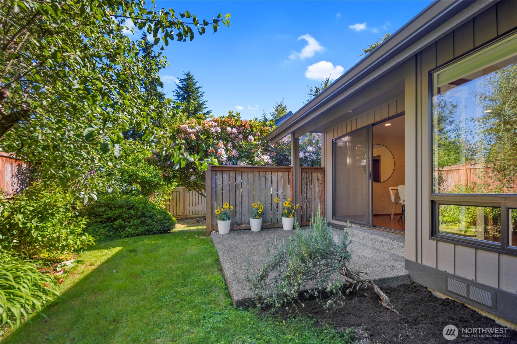 The private patio is ready for use as an outdoor entertaining space or to relax and enjoy the peaceful surroundings