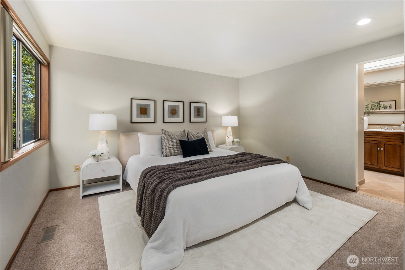 Retreat to this primary suite featuring plush carpet and ample space for a king sized bed