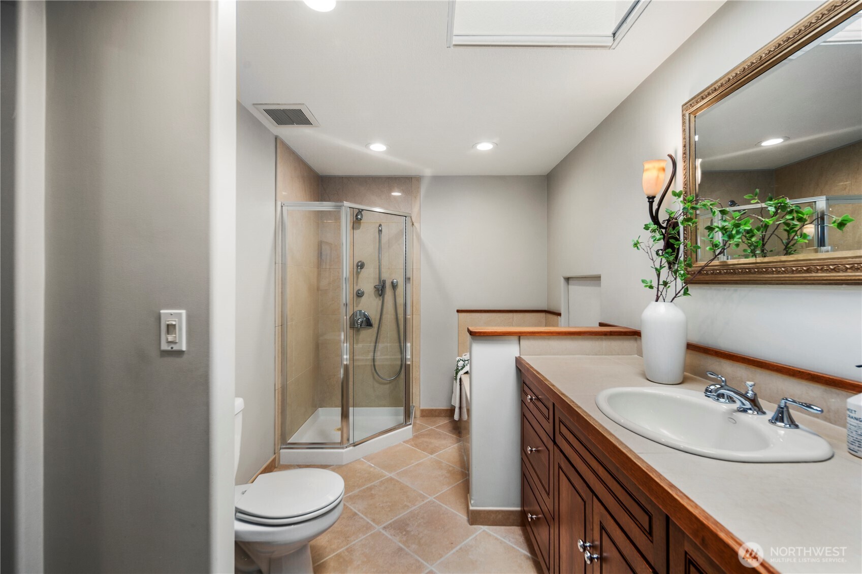The primary ensuite bath is perfect for self care days with a jetted tub, separate shower space, and skylight that allows just the right of amount of natural light to trickle in