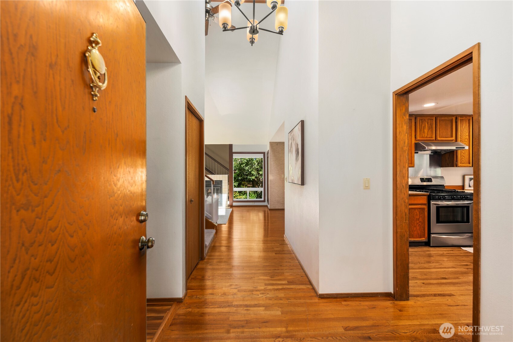 Step inside to reveal an entryway boasting vaulted ceilings, hardwood floors and flooded with natural light from the large windows and skylights throughout the home