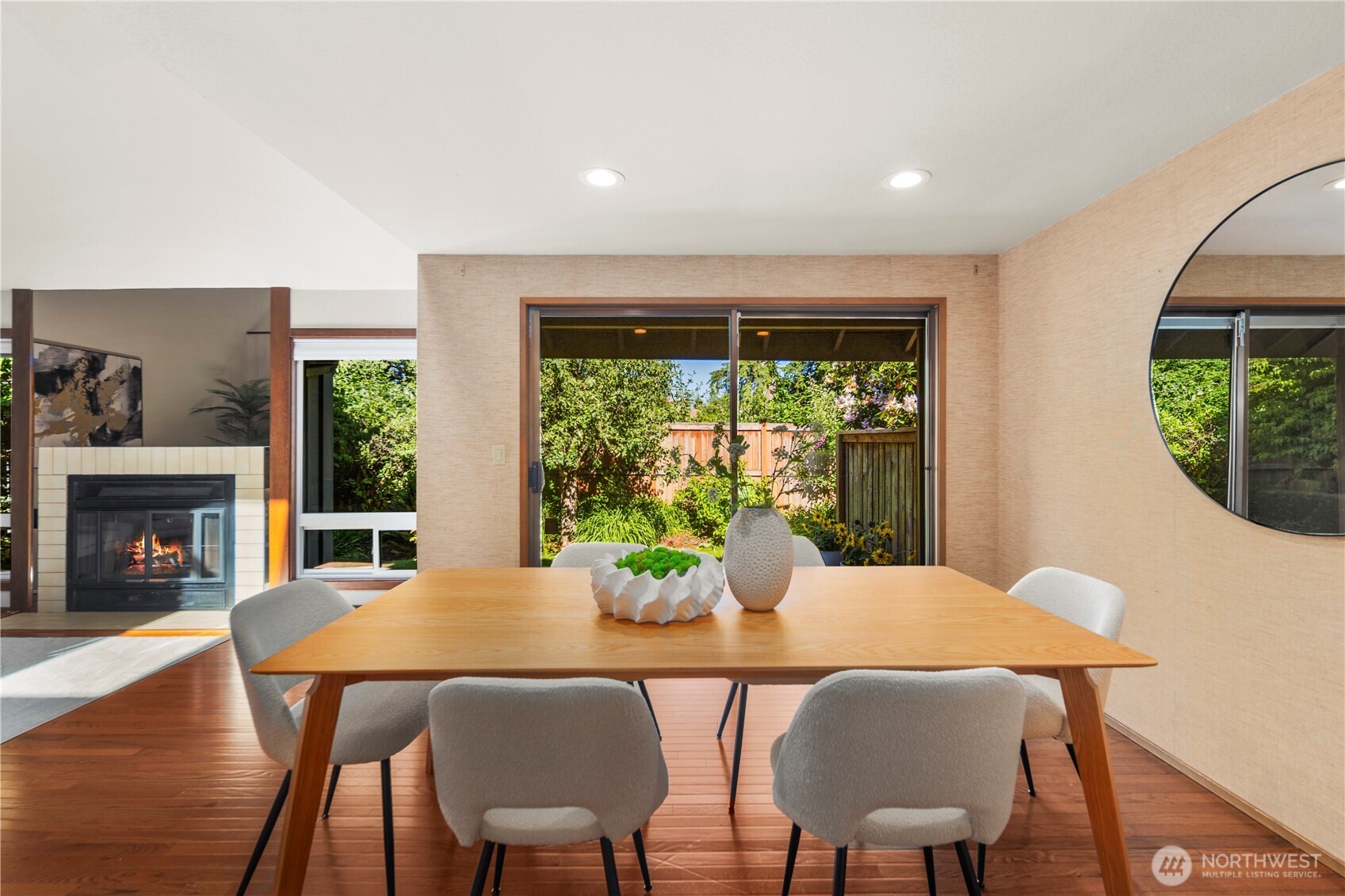 Enjoy the view from the dining space of the garden in the backyard through the sliding door leading to a private patio