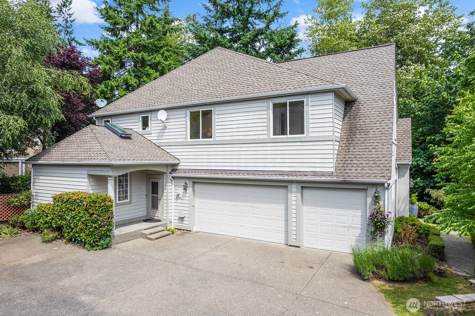 Side of home entrance and 3 car garage.
