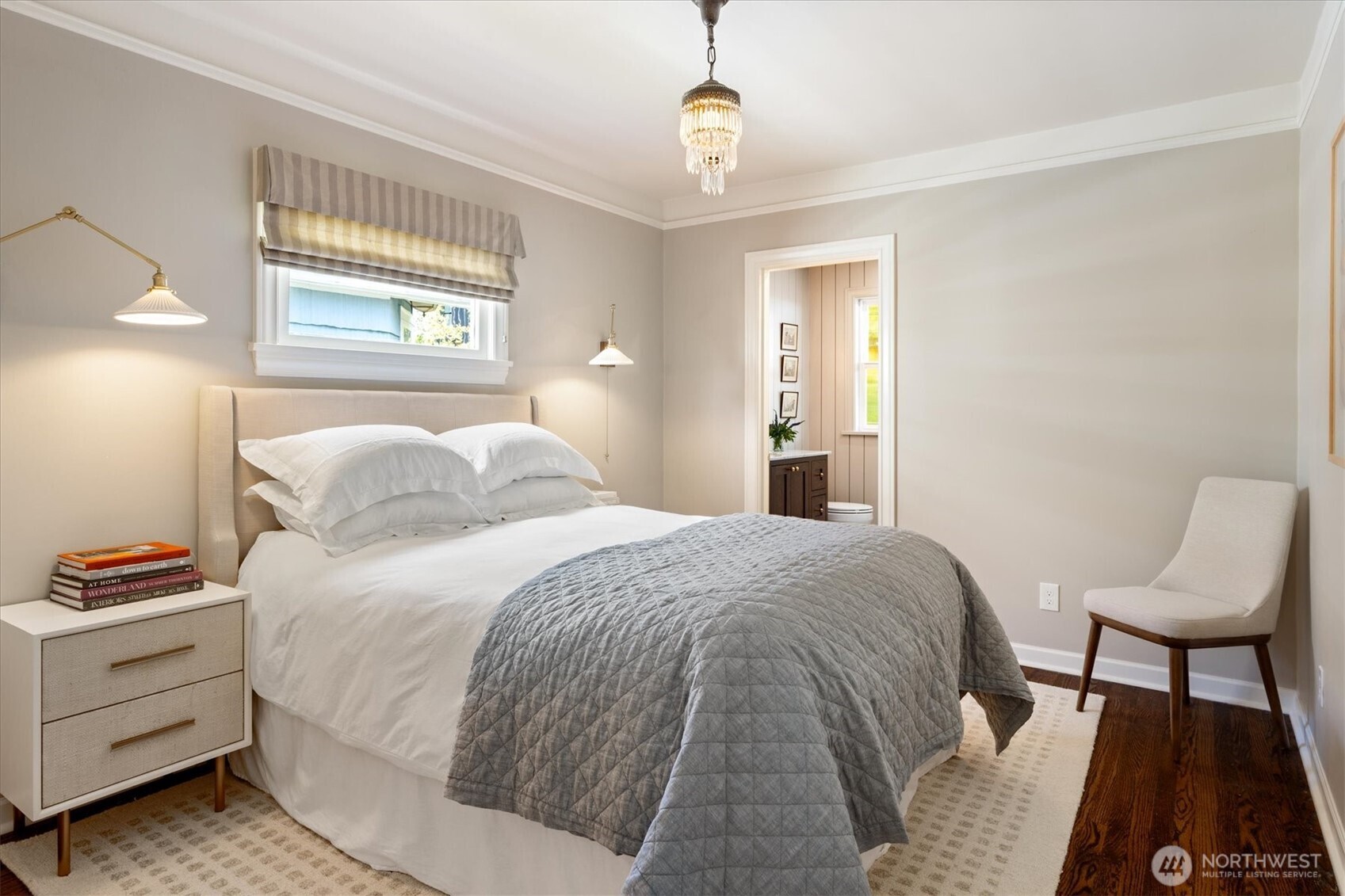 Primary bedroom with perfect reading sconces and en suite bath.