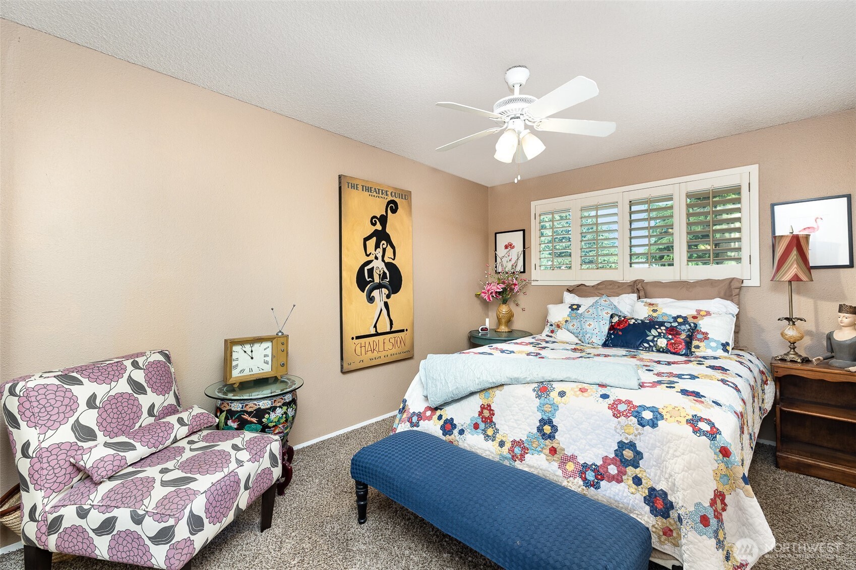 Large guest bedroom upstairs with ceiling fan.