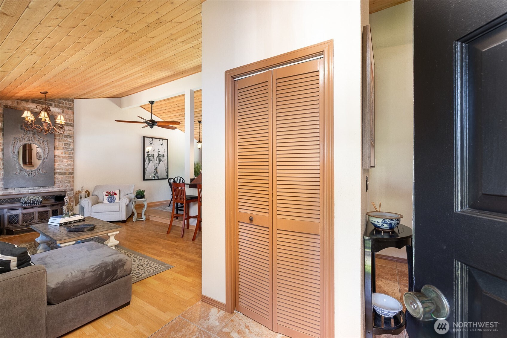 Opens to spacious living area and closet storage.