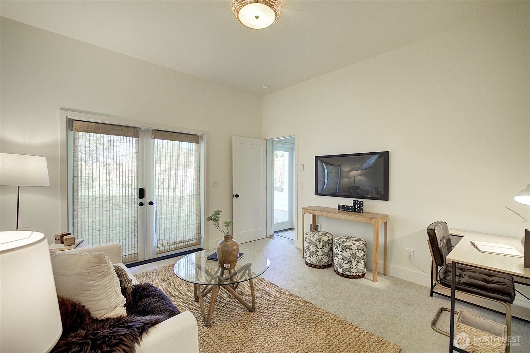 Lower level bedroom with double door entrance to heated patio