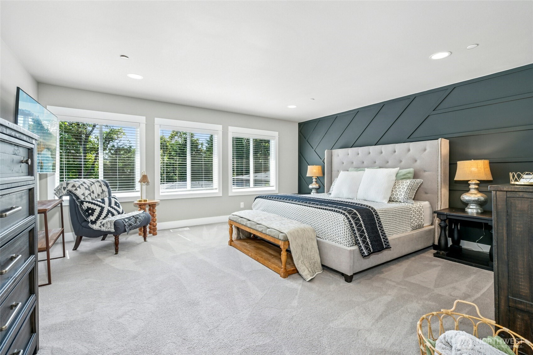 Light-filled primary suite provides a true retreat with dual walk-in closets and a luxurious five-piece bath designed with spa-like tranquility.