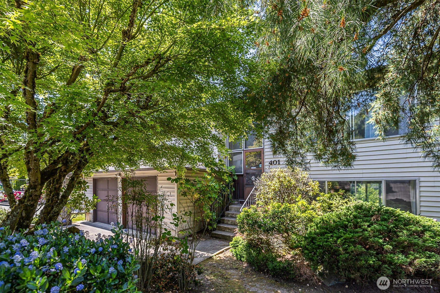 Great curb appeal enhanced by lush, mature landscaping.