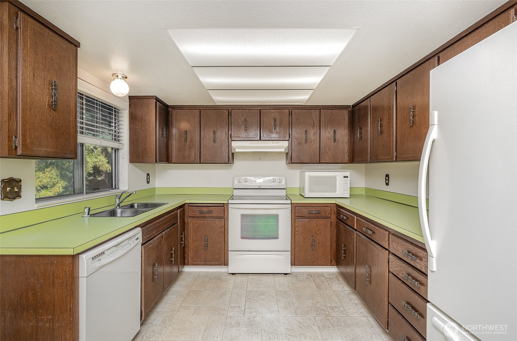 Kitchen features plenty of cabinet storage and ample counterspace.