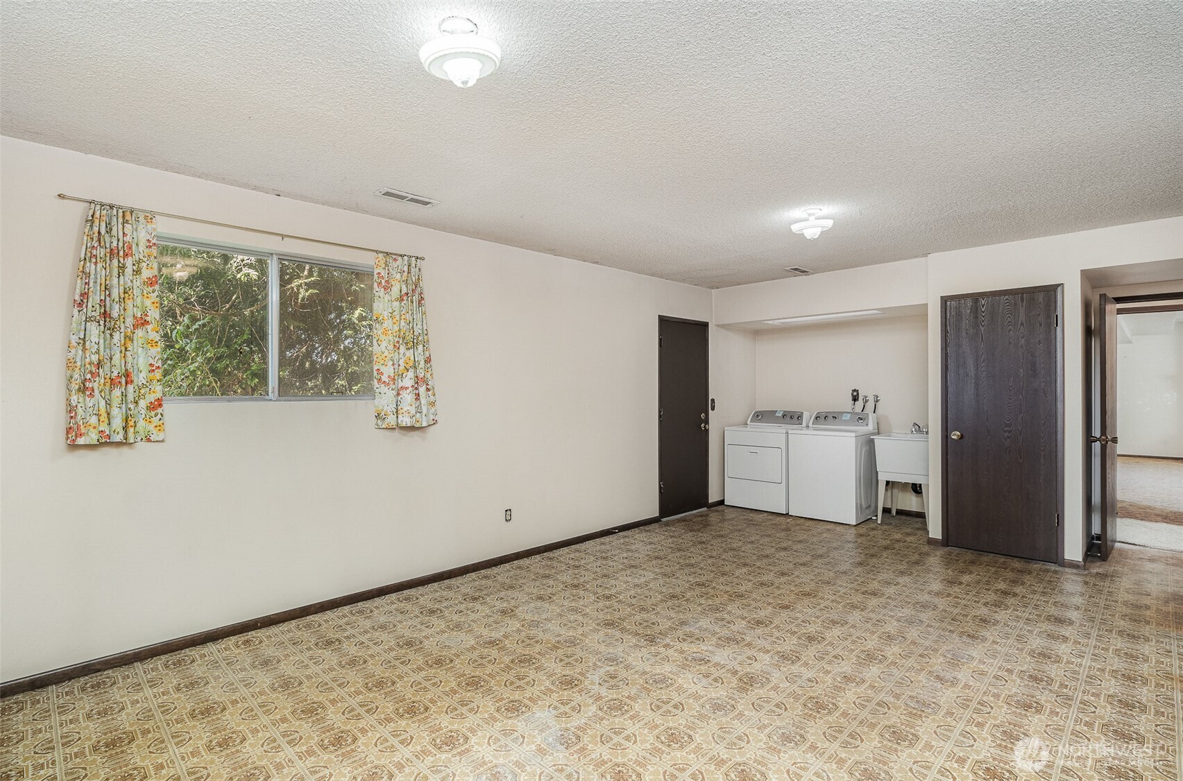 Oversized utility room with washer, dryer and utility sink.