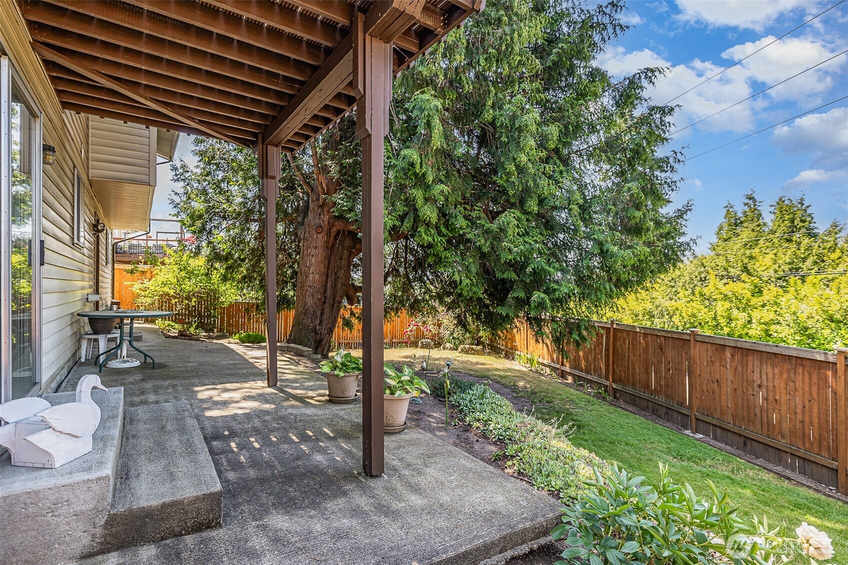 This extended patio offers a mix of covered and open-air space, ideal for relaxing or entertaining.