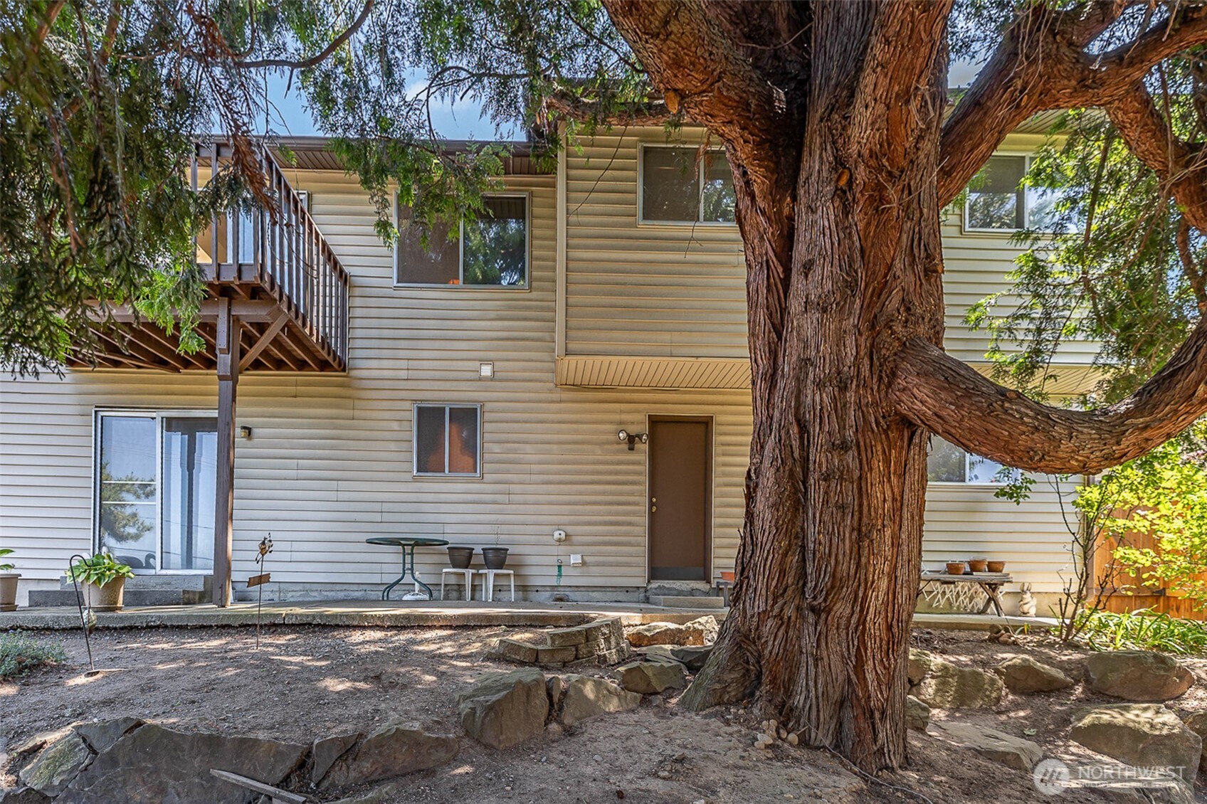 Another view of the backyard showcasing its spacious layout and lush greenery.