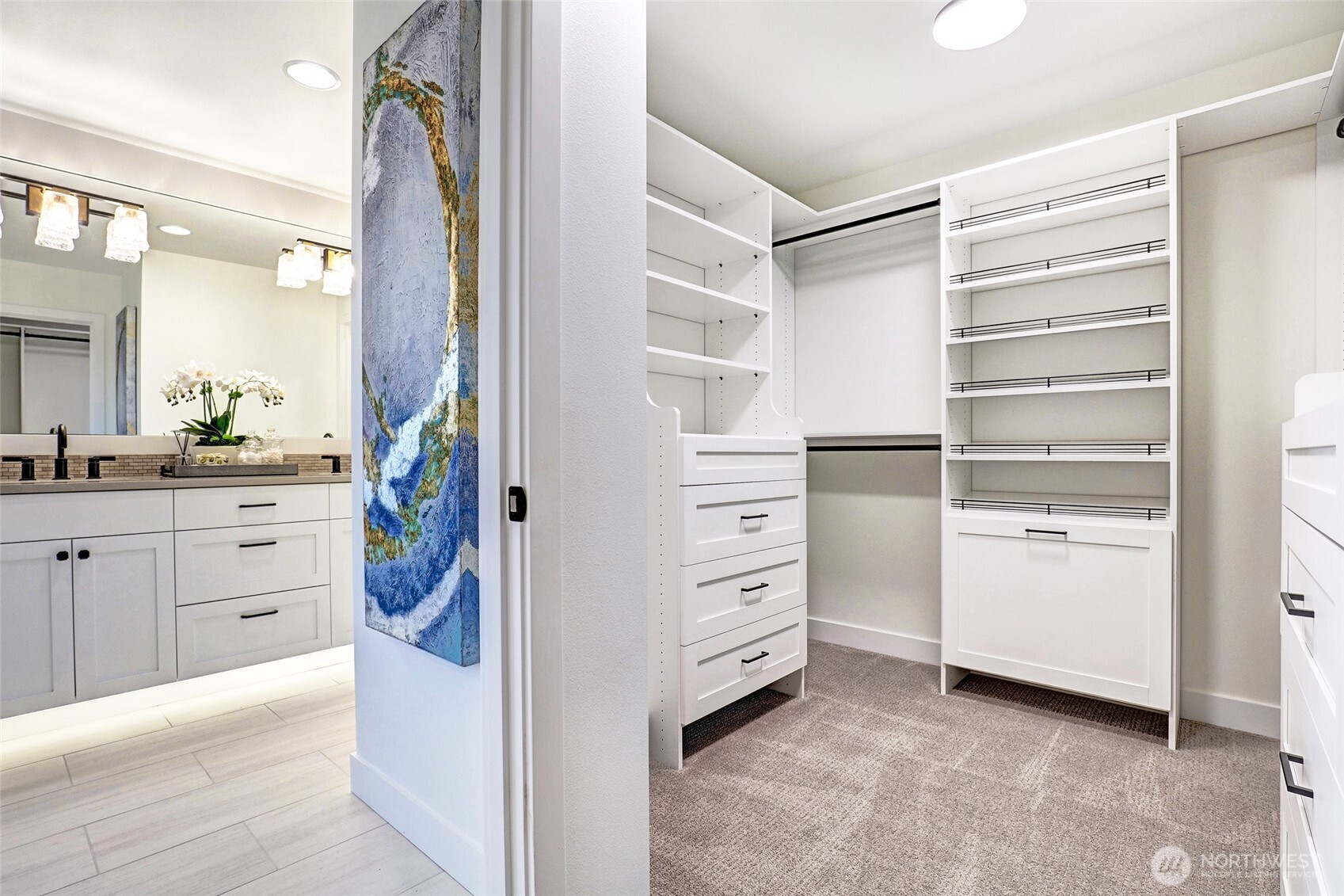 Primary bedroom walk in closet with high end custom build outs!