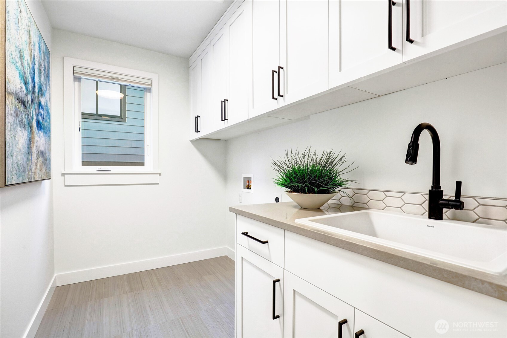 Spacious upstairs laundry room with soaking sink makes doing the laundry a breeze! There's also a W/D hookup on the lower level so there's now need to carry laundry upstairs!