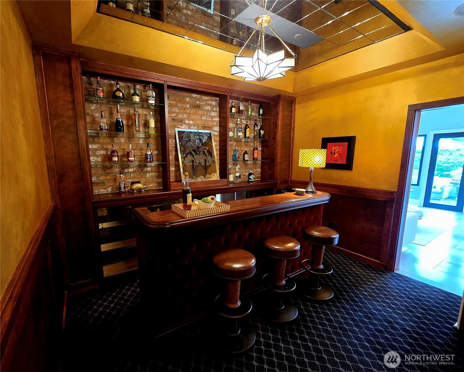 Speakeasy bar with access off kitchen and sun room.