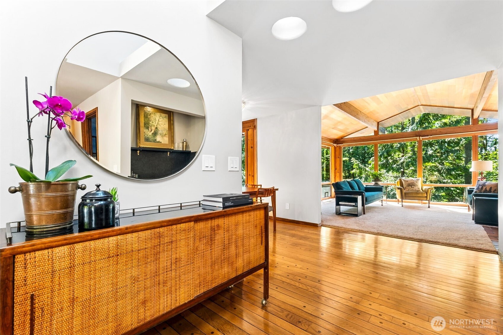 Entry is so welcoming, with high ceilings and main skylight in ridge of roof. The home was originally designed to be self-cooling in the summer, by opening windows on the lower level of the home and on the main, then opening the ridge skylight to let all the heat escape! But don't worry, it now has mini-splits as well to provide cooling on the hottest of summer days!
