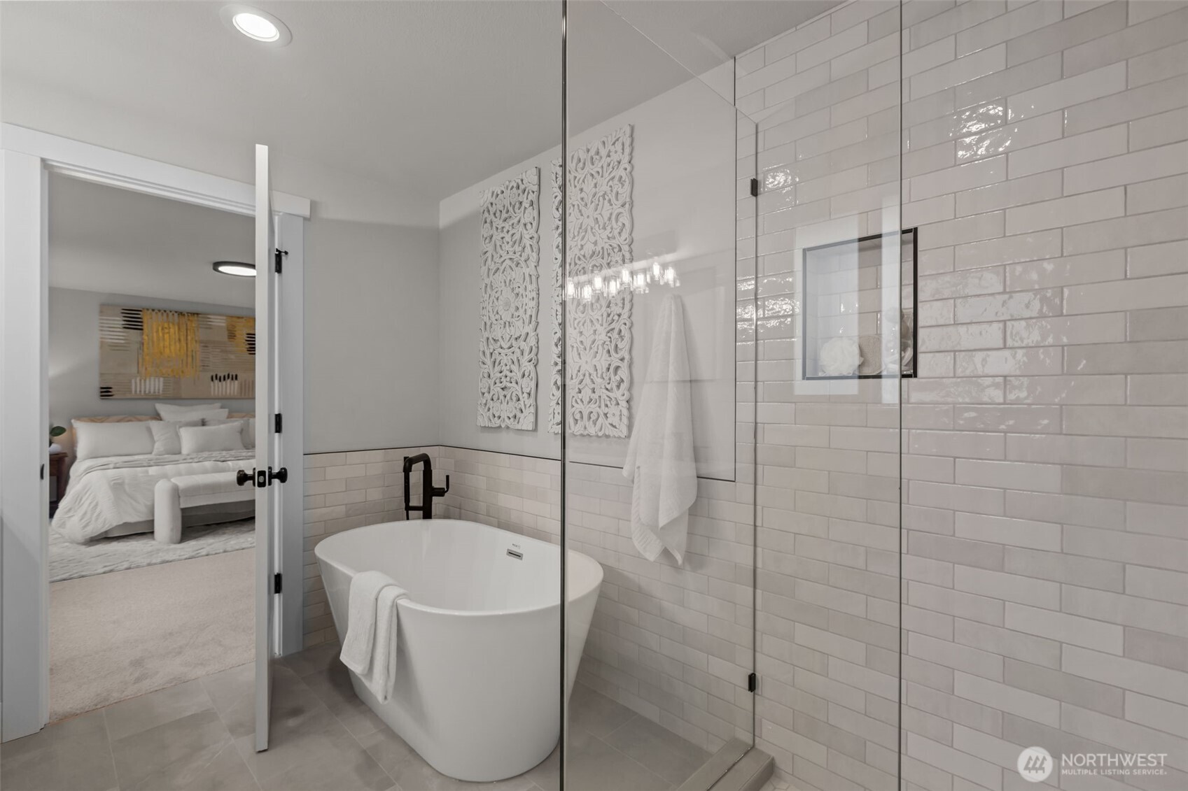 Enjoy your own personal spa with this gorgeous glassed in shower and free-standing bathtub.