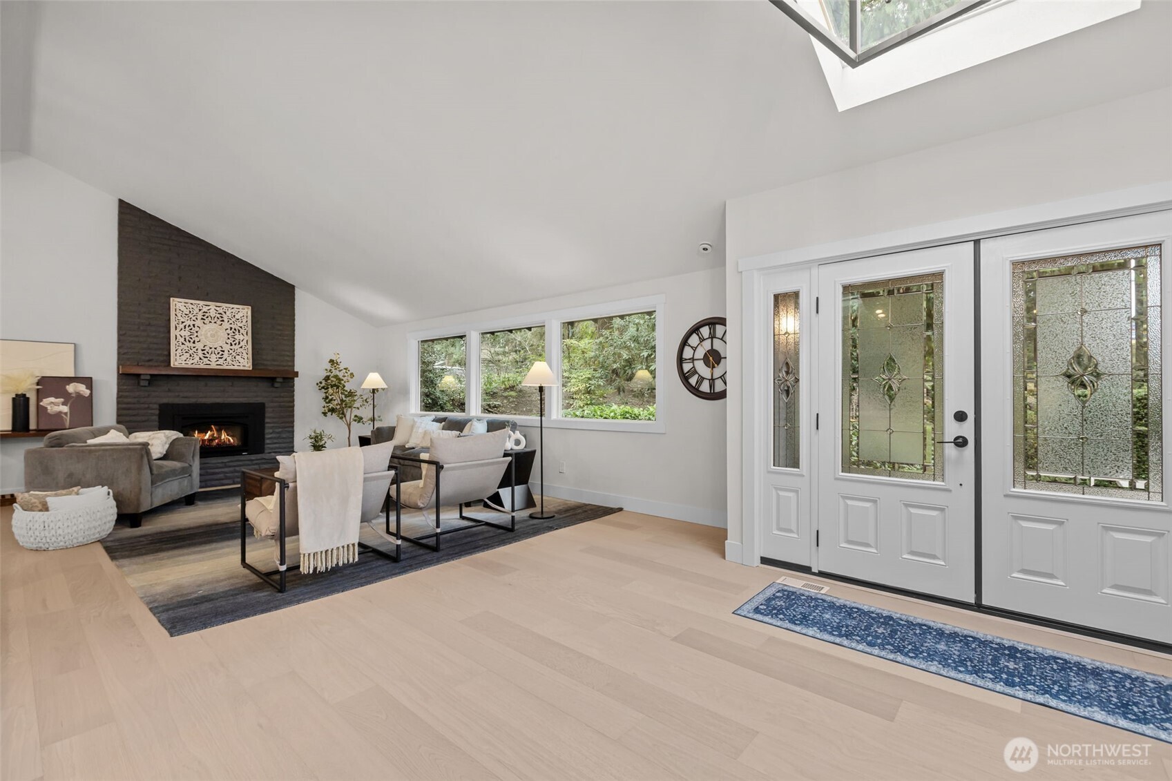 Natural light abounds throughout entire home, featuring large windows and skylights.