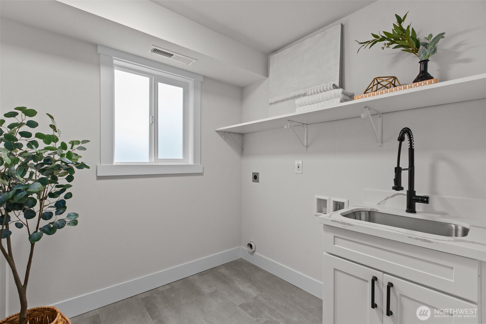 This light, bright utility room even features a laundry-chute from the bedroom wing upstairs!
