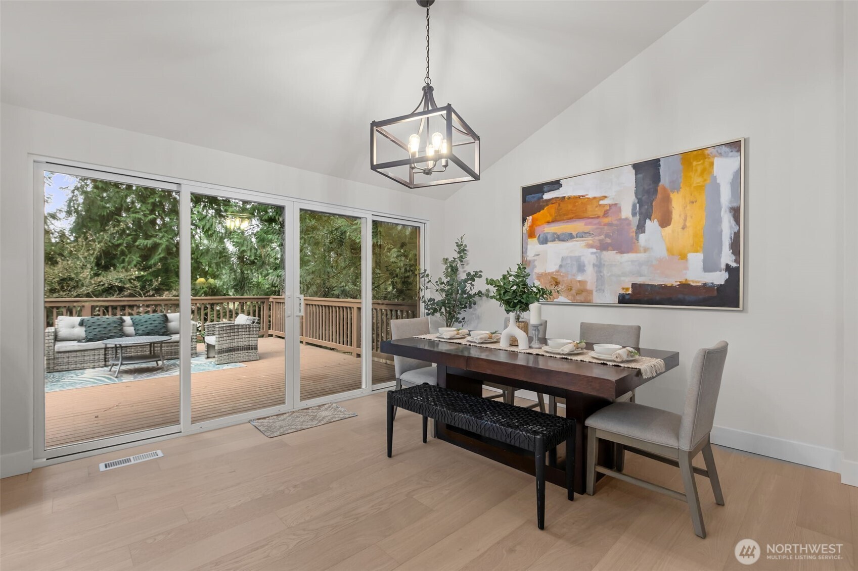 Your dining room looks out over a huge new entertaining deck with a wall of windows and double sliders.