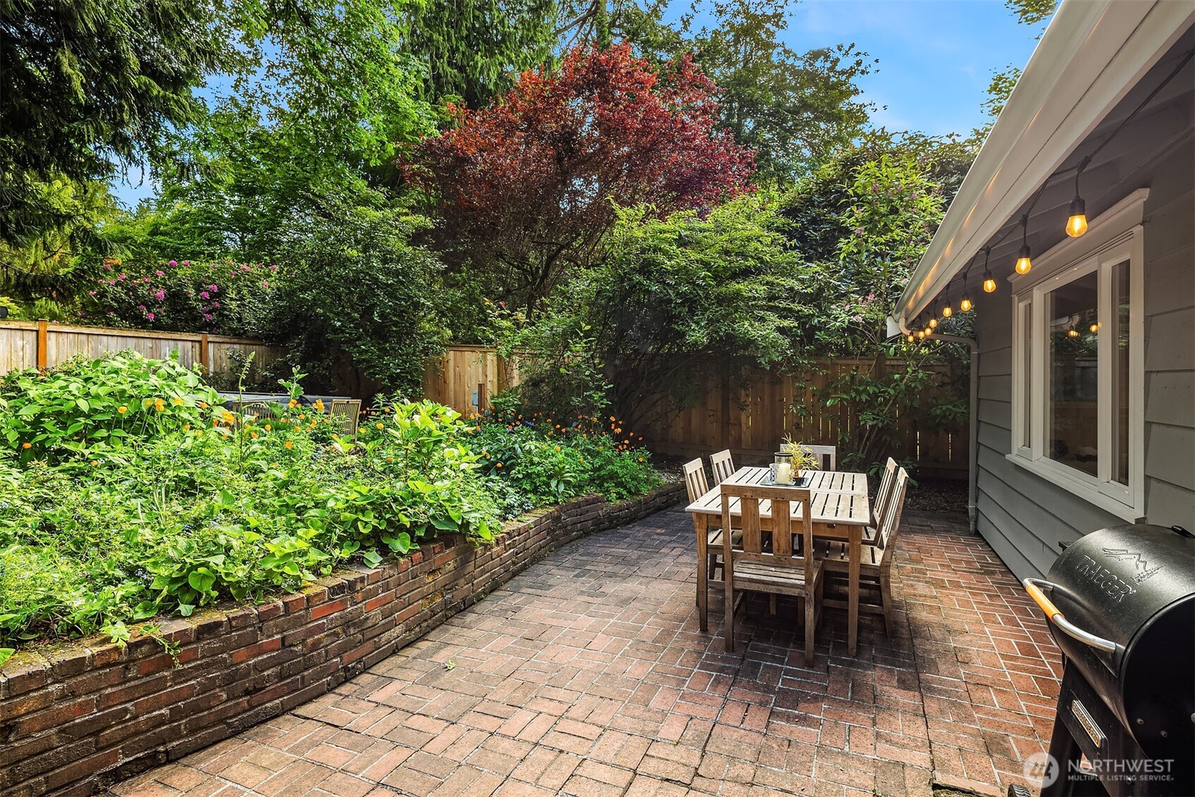 Almost radiating an "old world" vibe, this weathered beautiful brick patio adds a layer of texture and warmth while dining al fresco in the back yard paradise.