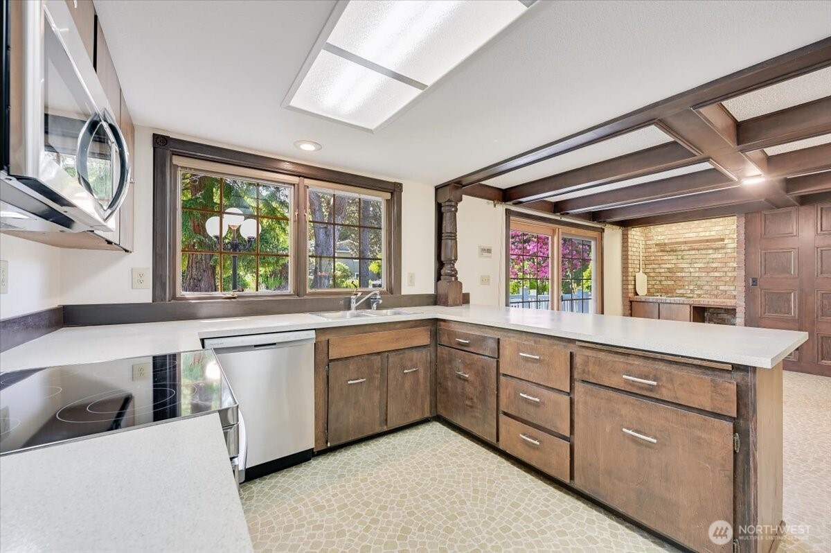Large kitchen features new stainless steel appliances, breakfast bar and large eating area
