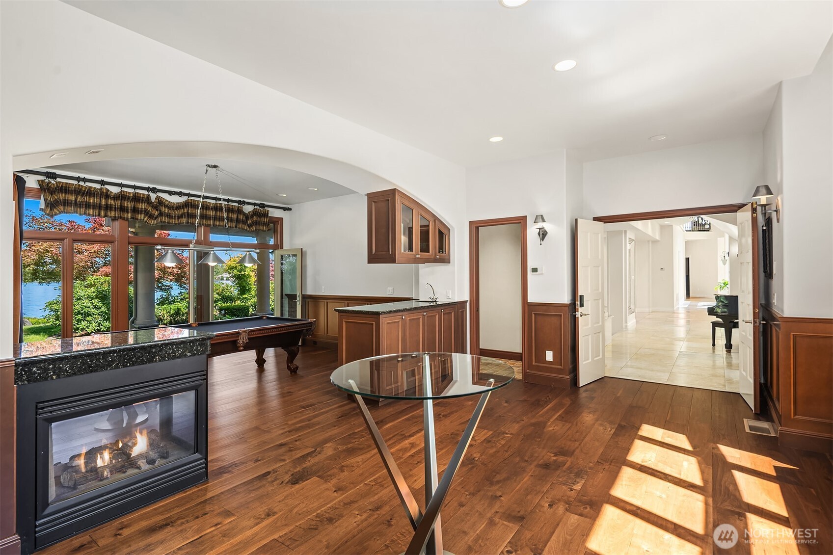Glass French doors lead to covered patio. Wainscoting wrap the parlor. Bar w/refrigerator & sink.
