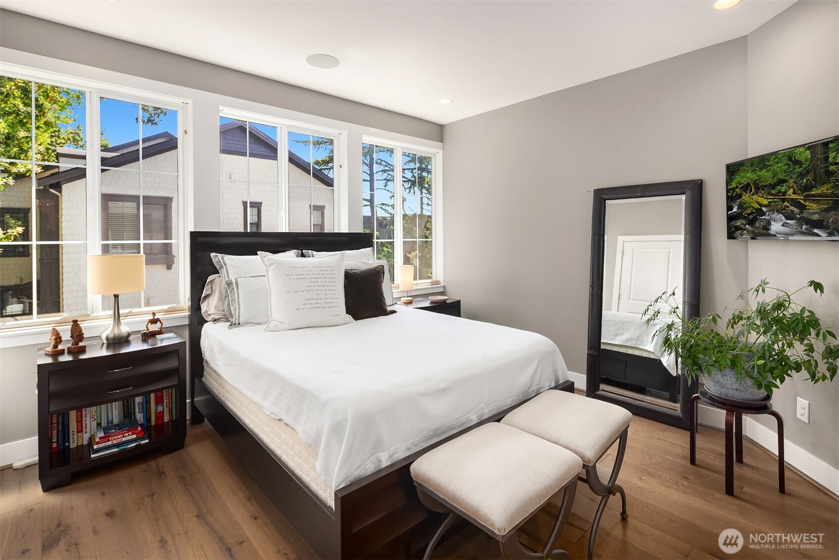 The spacious primary suite is filled with natural light, creating a bright and inviting retreat.