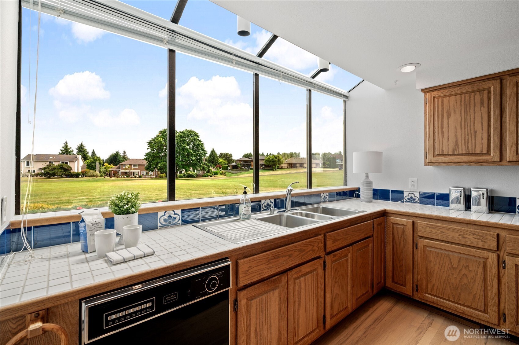 A spacious and elegant Kitchen featuring stainless steel appliances, dual ovens, and custom cabinetry, complete with a breakfast island perfect for quiet morning conversations.