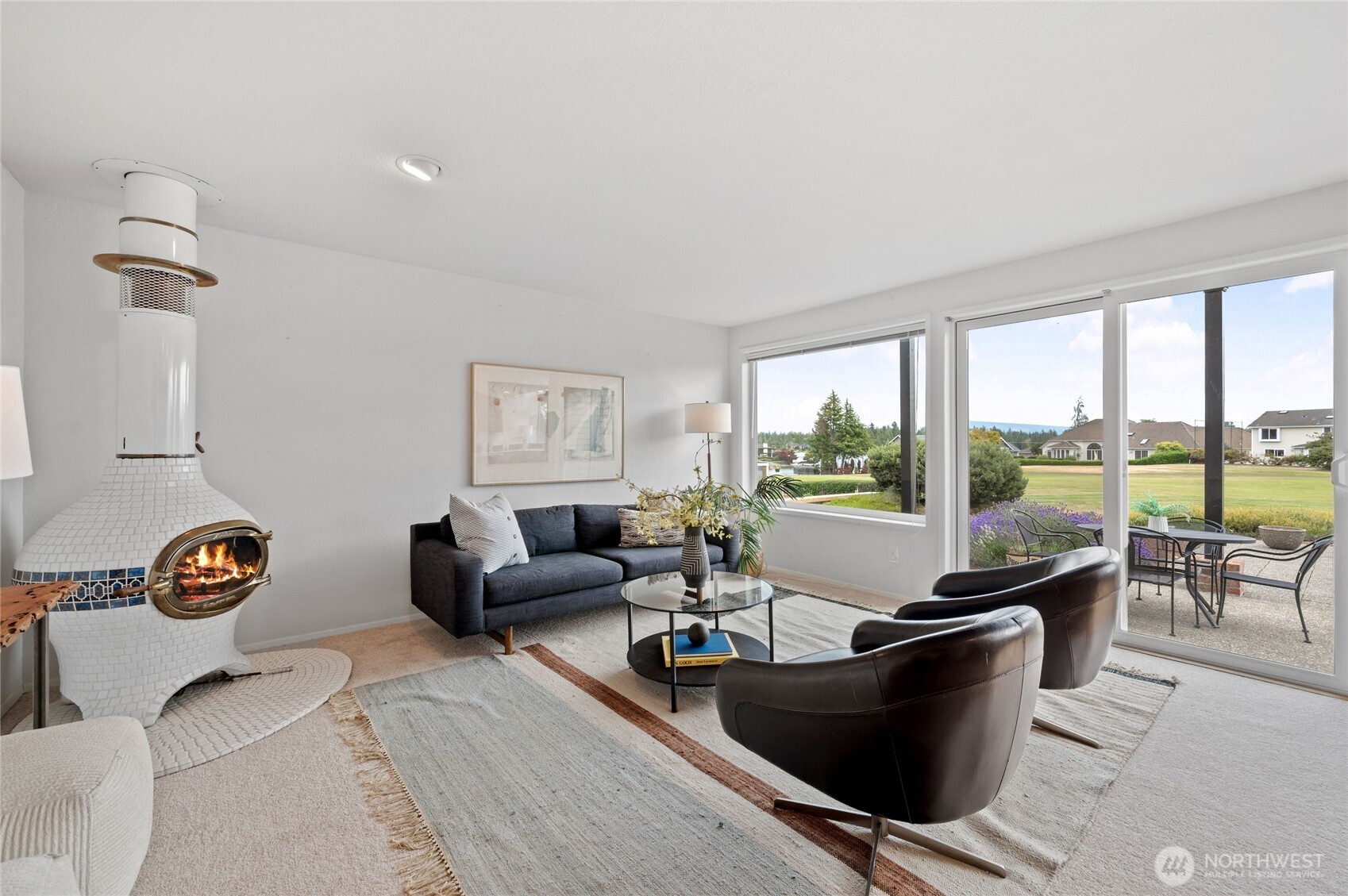 The Kitchen extends into a welcoming Family Room, where a custom wood-burning stove creates the perfect ambiance for quiet evenings or lively conversation.