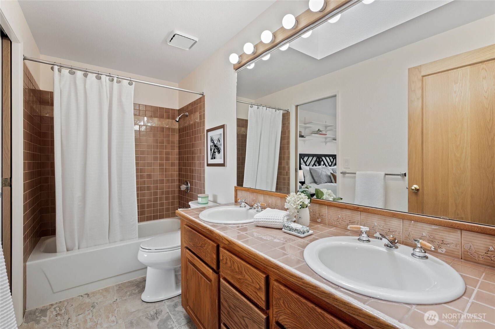 Thoughtfully designed, the second bedroom also includes direct entry to a Jack-and-Jill bathroom that opens to the upstairs hall—an inviting arrangement for guests.