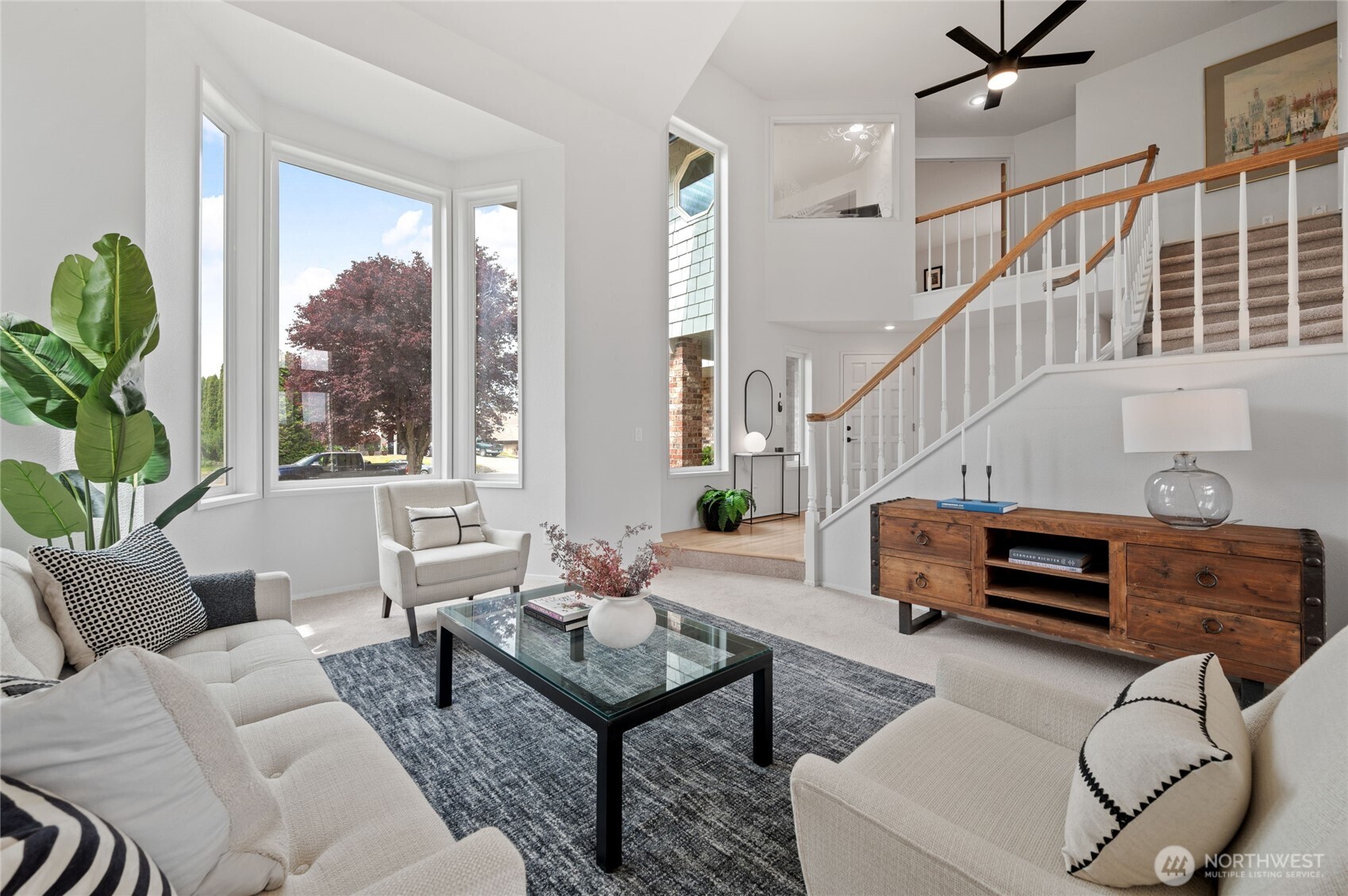 View from the Living Room to the entry on the left, Dining Room on the right. Three bedrooms are located upstairs.
