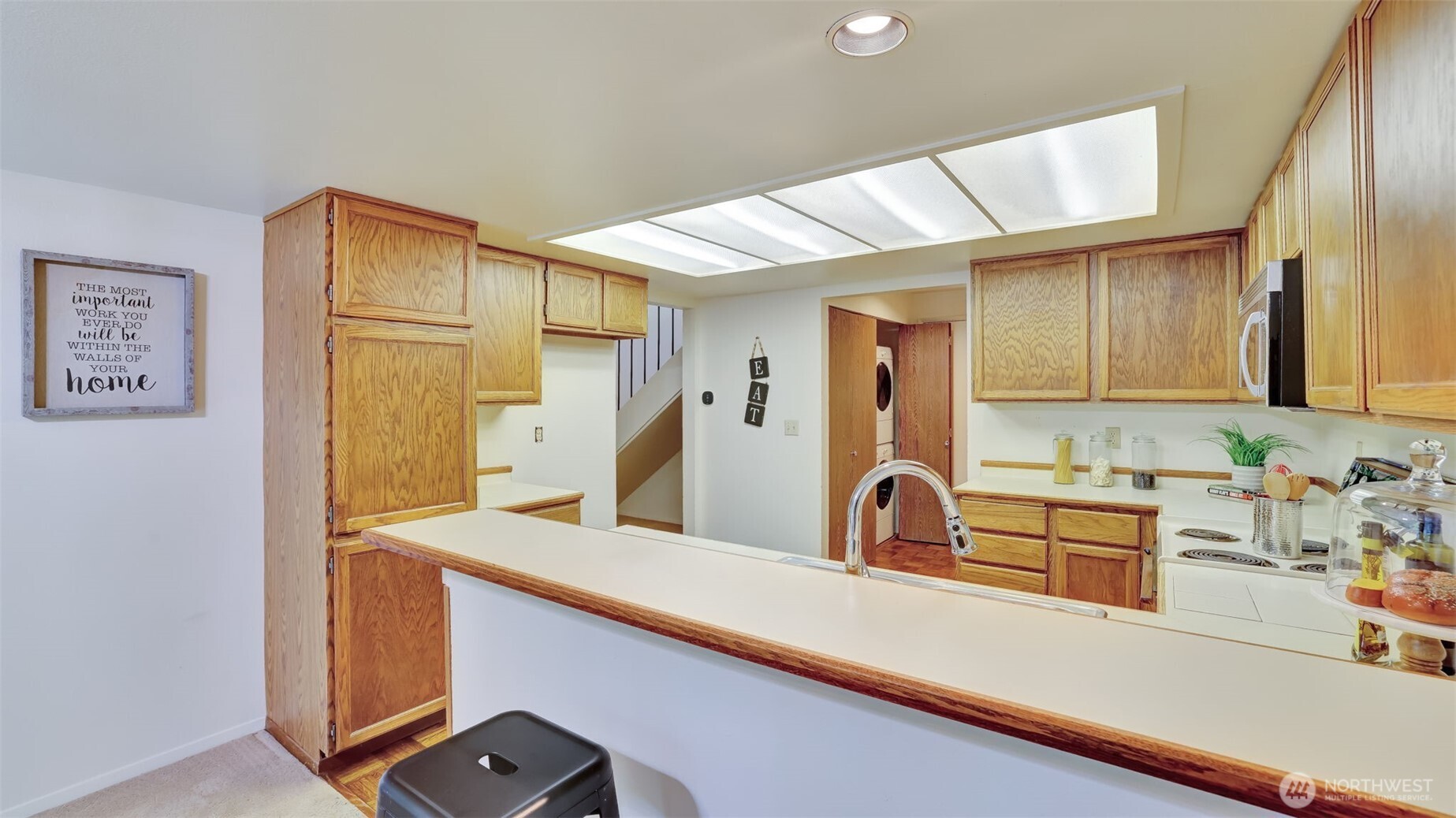 Enjoy ample cabinet space to store all your kitchen supplies neatly and efficiently. Tucked into a convenient corner of the home is a dedicated laundry area, complete with a washer and dryer that are included in the purchase for added ease and functionality