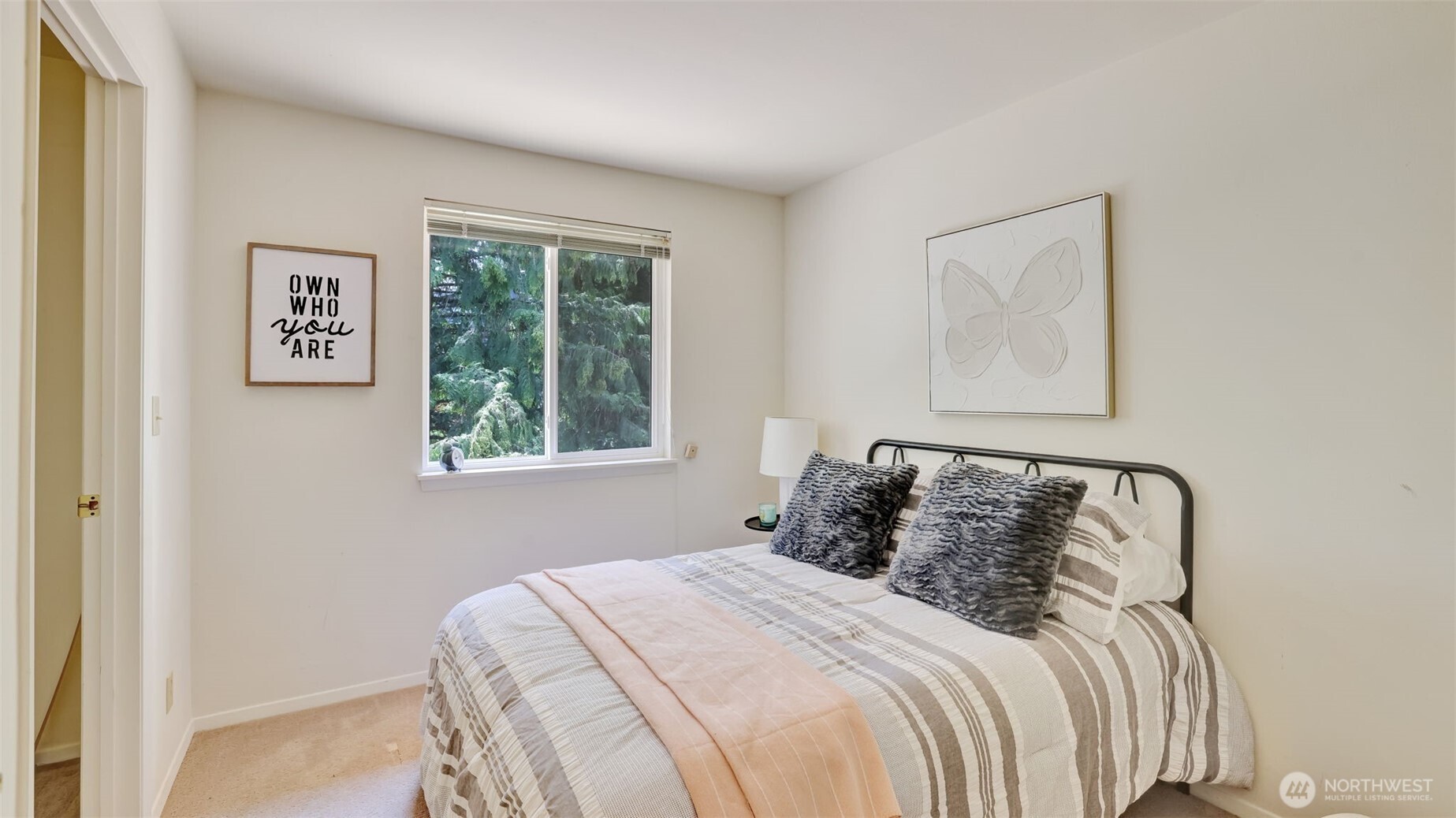 Featuring a walk-in closet and attic access, this roomy guest bedroom offers plenty of storage and comfort for your visitors