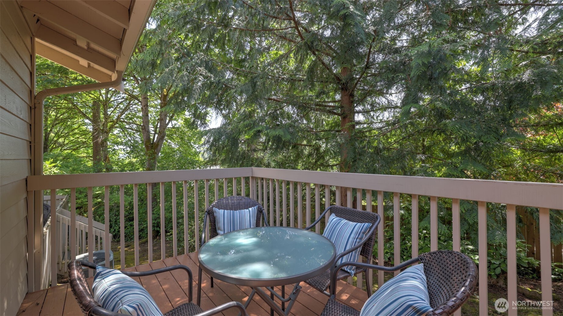 This outdoor deck offers stunning views of surrounding trees and abundant sunlight, making it the perfect spot to enjoy your morning coffee